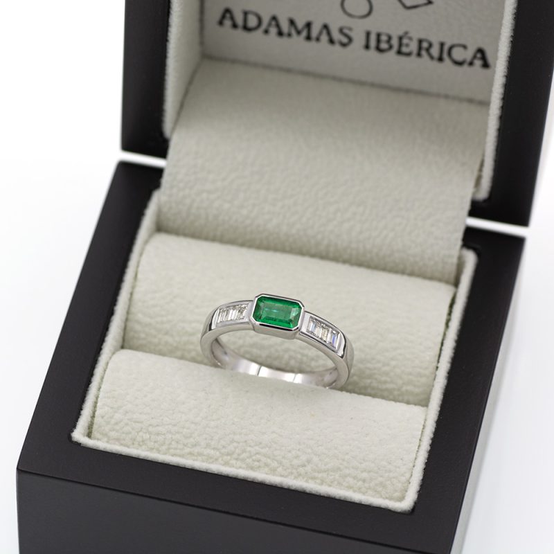 Anillo de oro blanco con esmeralda verde vivo y diamantes.